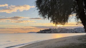 The sun hidden behind clouds and a tree over Kavala, Greece, reflecting divine hiddenness in Ecclesiastes.