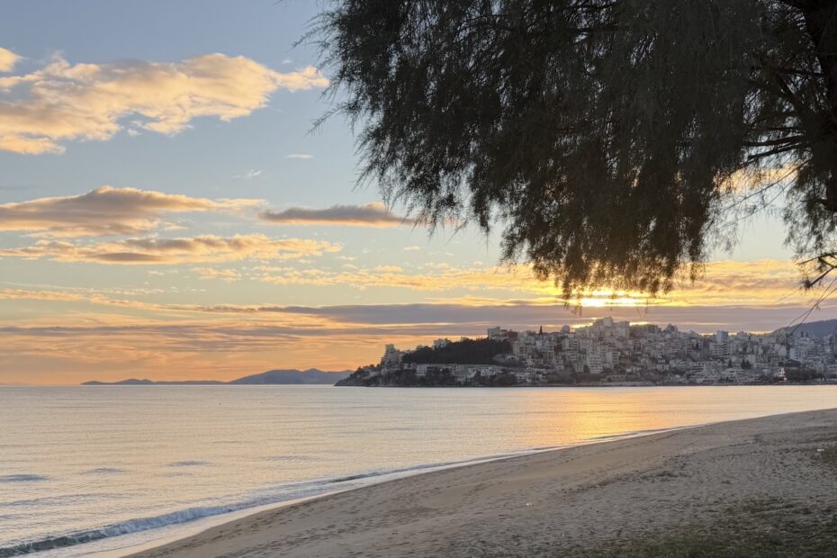 The sun hidden behind clouds and a tree over Kavala, Greece, reflecting divine hiddenness in Ecclesiastes.