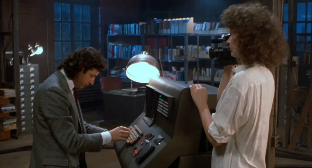 Seth Brundle and Veronica Quaife at the computer controlling the telepods in The Fly (1986)